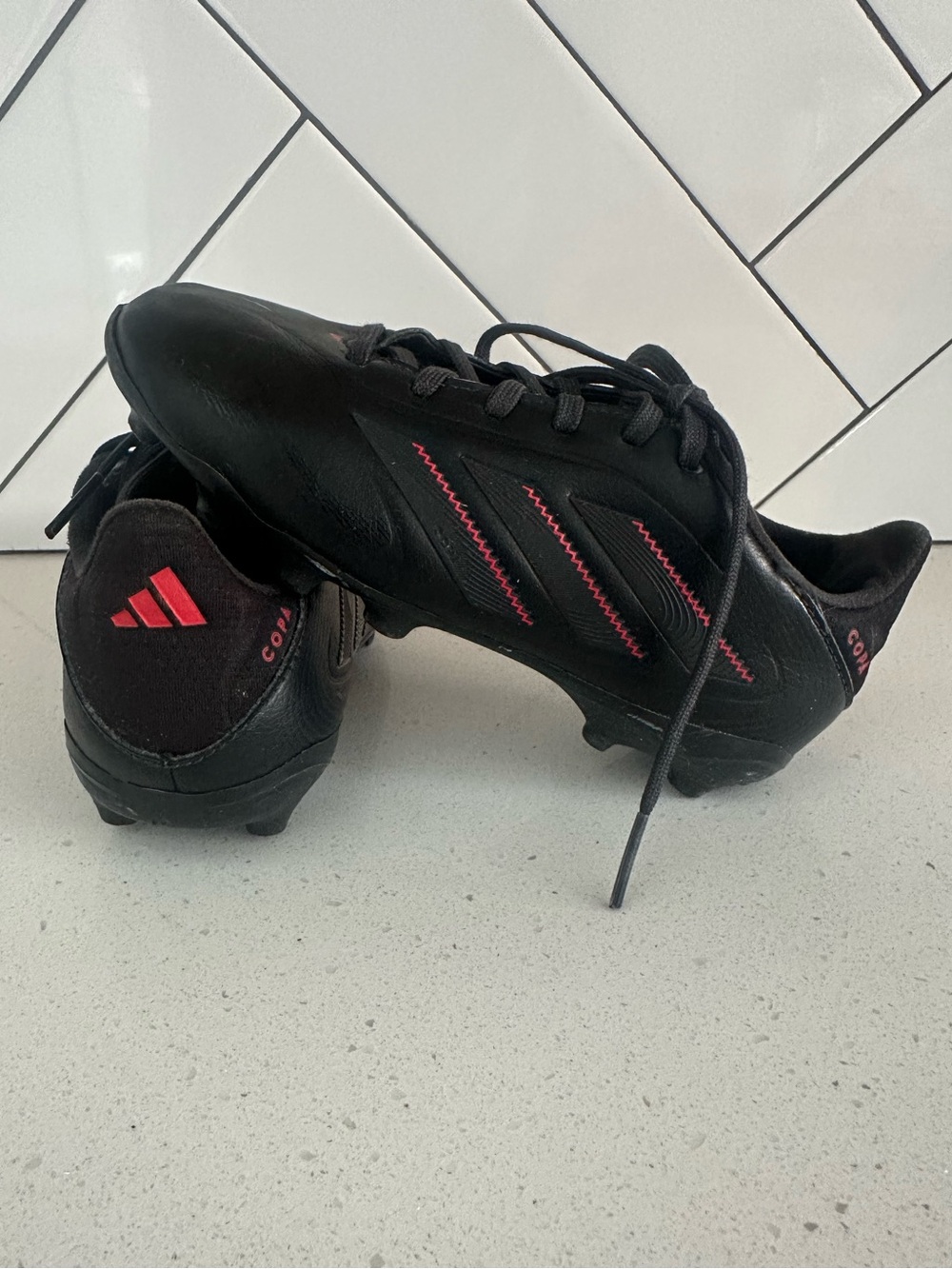 adidas Black Soccer Cleats with Red Accents